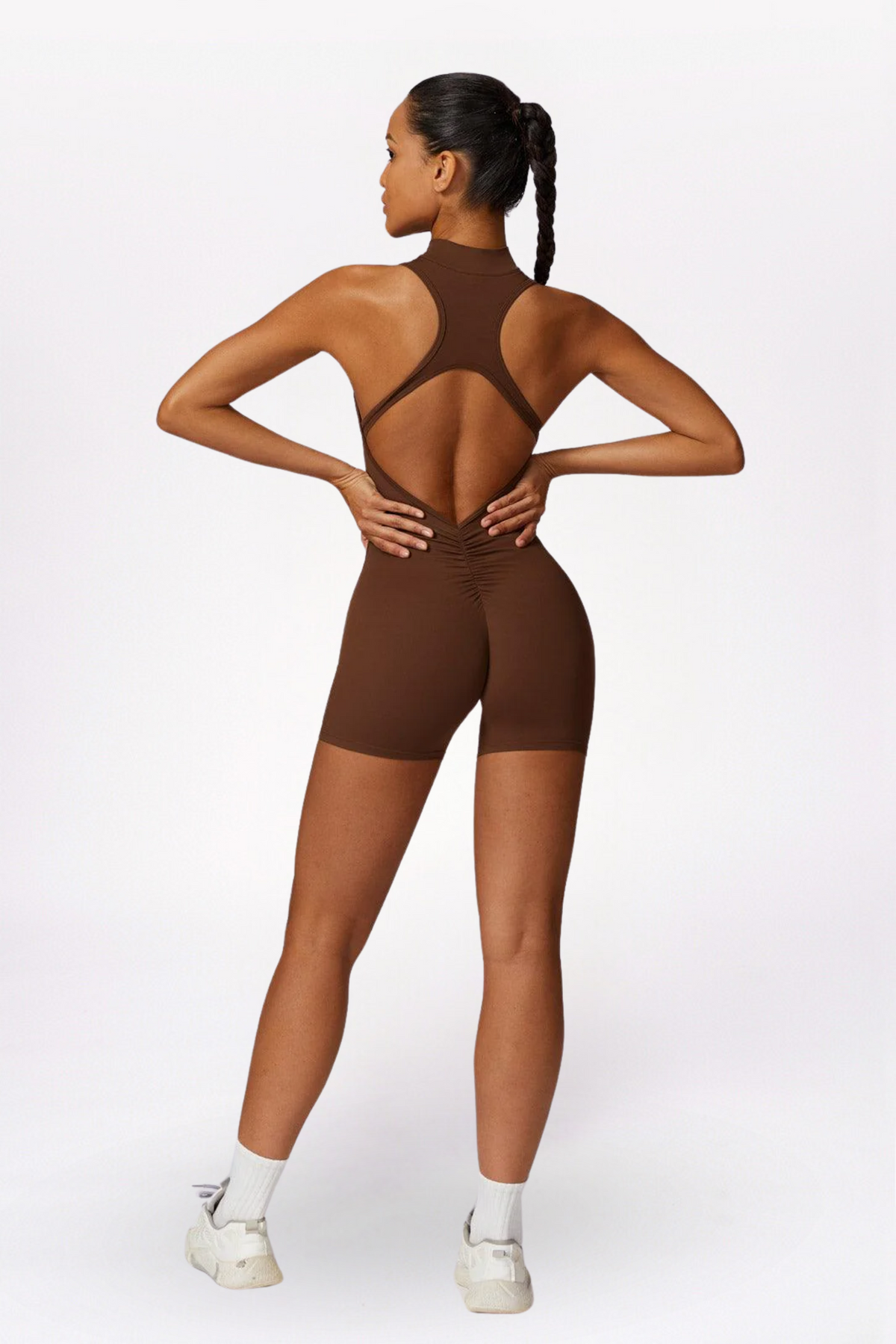 Woman wearing a brown bodysuit on a white background brand Gymelle