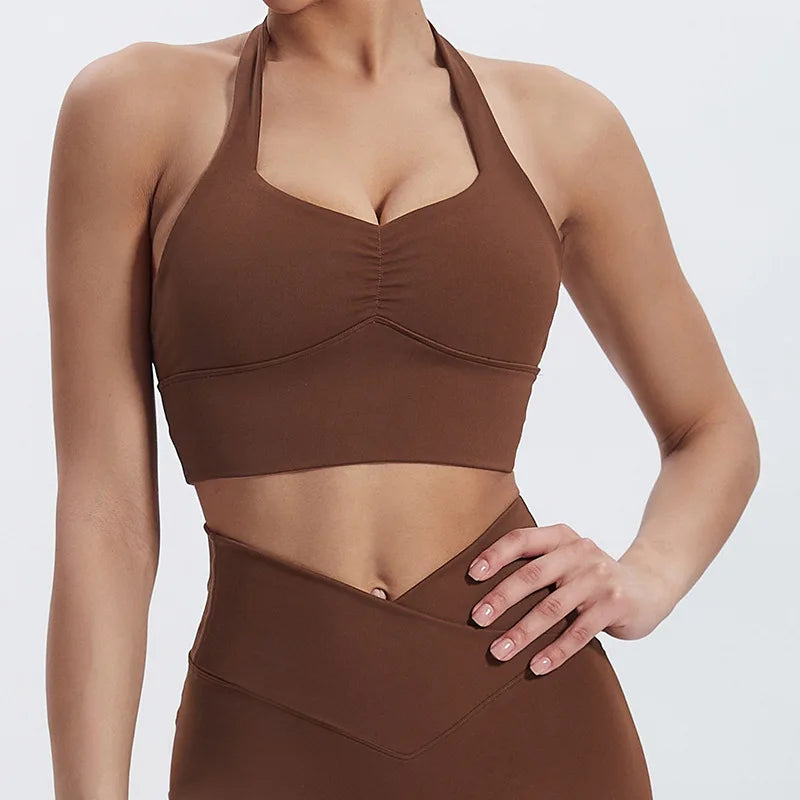 Brown sports bra and leggings set on a plain background brand Gymelle