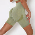 Green athletic shorts worn by a person on a white background