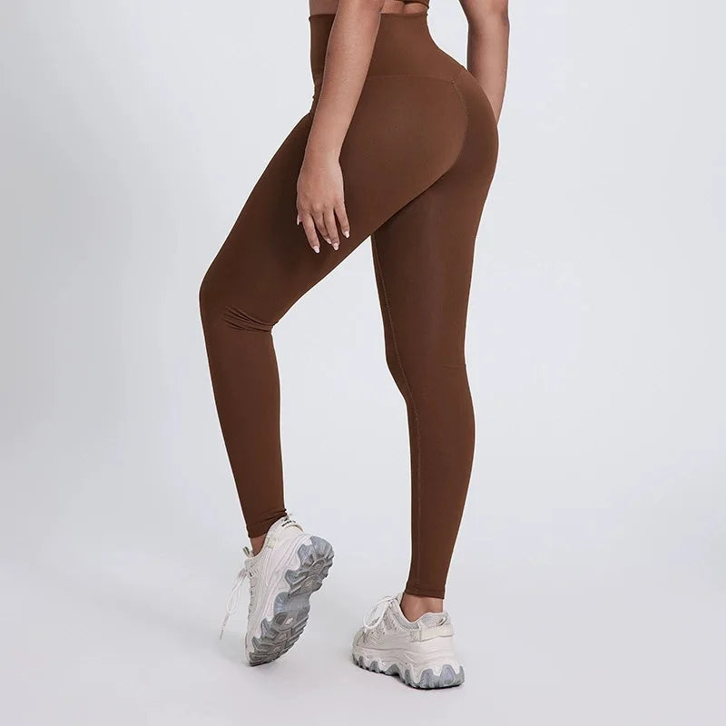 Brown leggings worn by a person on a white background brand Gymelle