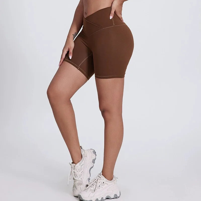 Brown athletic shorts worn by a person on a white background brand Gymelle