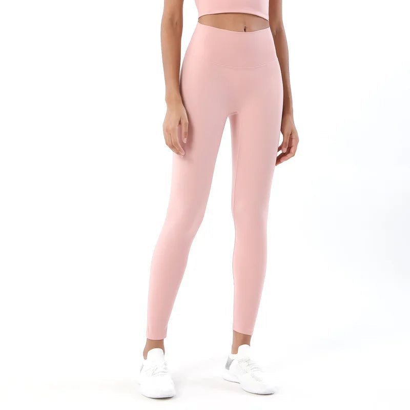 Person wearing pink leggings on a white background