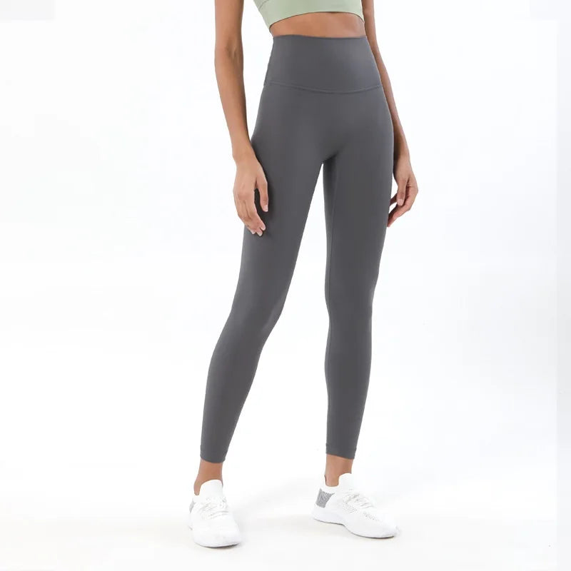 Person wearing gray leggings on a white background
